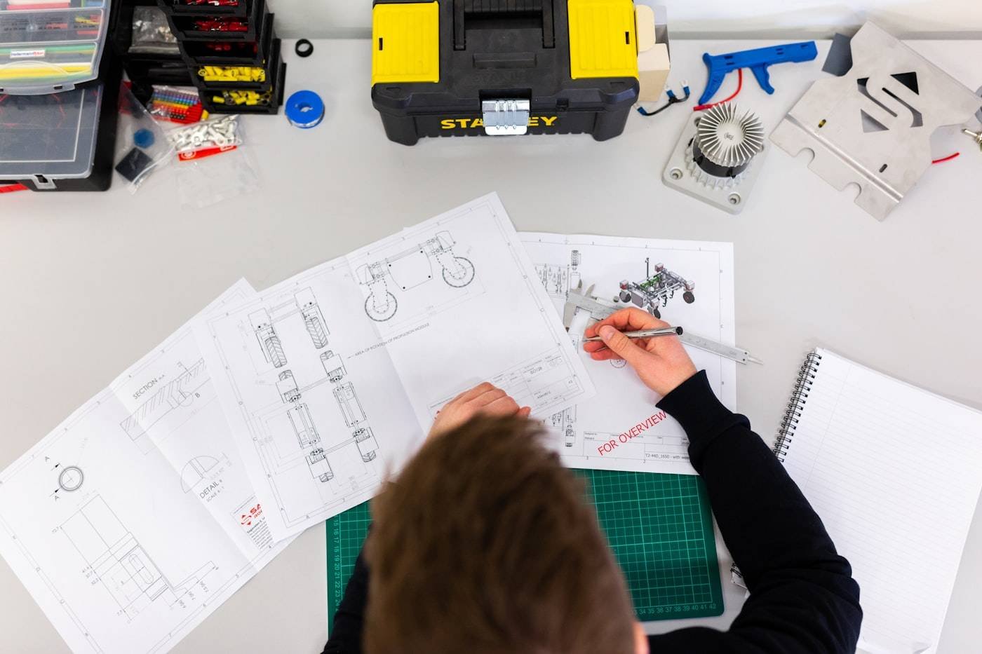 Engineer inspecting fabricated metal parts